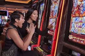 Filipino player browsing xgbet casino games on a smartphone showing slots and live dealer categories
